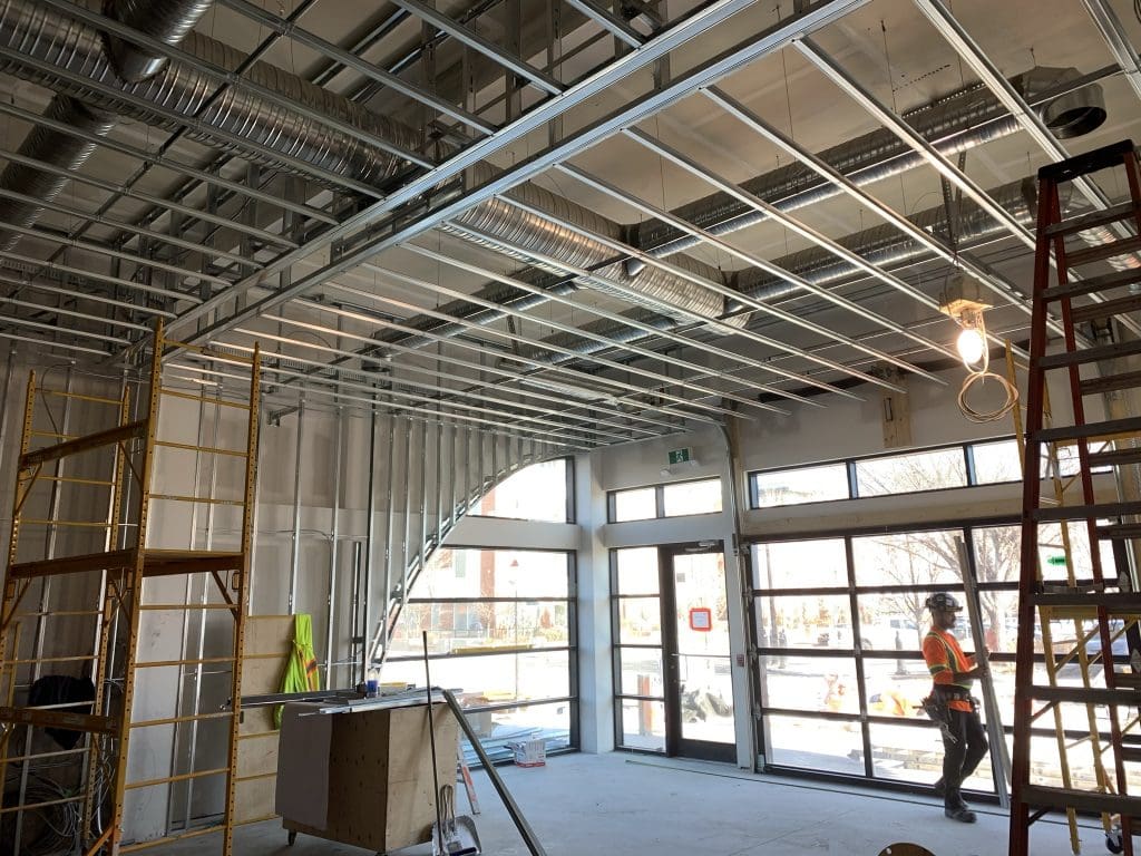 Drywall contractors of 51 North Interiors working on a drywall and framing project in Calgary, AB.